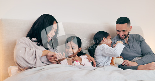 Image of Family, home and parents with children in bed for bonding, sleeping together and conversation. Night, support and happy mother, father and kids in bedroom talking for love, care and relax on weekend