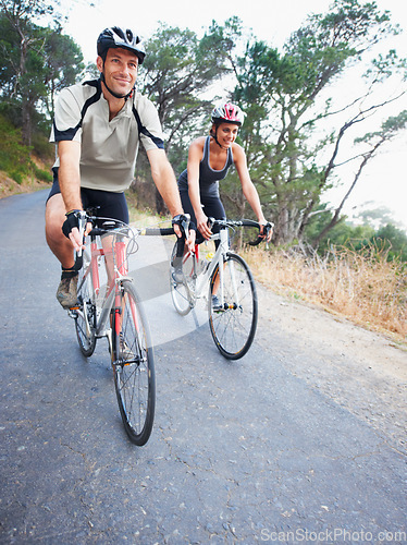 Image of Happy couple, cycling and road in nature for, fitness, training or travel on bicycle together. Outdoor, people and exercise on bike for fun, workout and path in countryside for adventure or journey