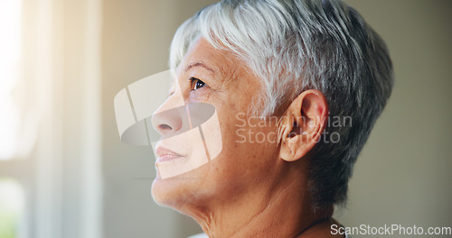 Image of Senior woman, thinking and looking out window in memory, ambition or dreaming in retirement home. Closeup or face of mature female person in wonder, contemplating or thought for idea or hope at house