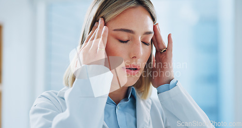 Image of Doctor, woman and headache in office with burnout, stress and risk at hospital or clinic from migraine. Person, employee or professional with wellness, anxiety or discomfort from strain at workplace