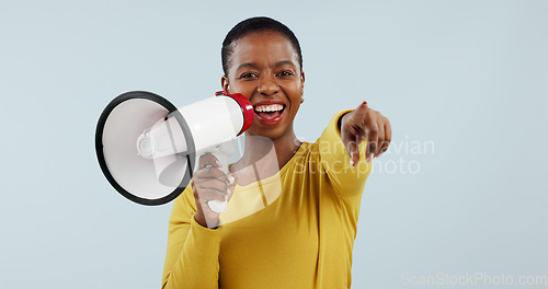 Image of Happy black woman, portrait and pointing to you with megaphone for choice against a gray studio background. African female person smile with loudspeaker or bullhorn for selection, choosing or sale