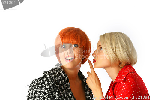 Image of Two happy young women whispering and surprised