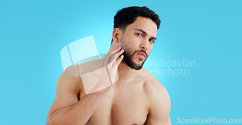 Image of Man, portrait and beard in grooming, skincare or hygiene isolated against a blue studio background. Face of handsome or attractive male person or model in beauty, facial cleaning or routine on mockup