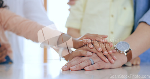 Image of Family, hands together and holding with closeup in home for trust, support and care. Man, woman and kids with pile for unity, community or collaboration on table in kitchen with generation for future