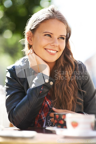 Image of Teenager, smile and relax at outdoor coffee shop, cafe or restaurant with espresso, latte or beverage. Happy, girl and sitting with green tea, drink or calm brunch in summer, morning or city bistro