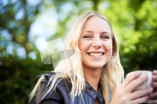 Image of Teenager, smile and portrait outdoor at coffee shop, cafe or restaurant with espresso, latte or beverage. Happy, girl and relax with green tea, drink or calm brunch in summer, morning or garden