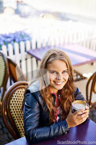 Image of Portrait, happy and woman at outdoor cafe, drink and restaurant table. Face, smile and person at coffee shop with tea cup, espresso and customer with latte to relax in city cafeteria in Switzerland