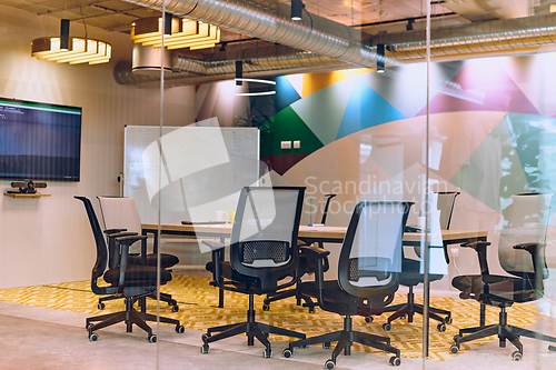 Image of In the contemporary setting of an empty modern glass startup office, the space exudes a sleek and innovative atmosphere, ready to be filled with the potential of entrepreneurial endeavors