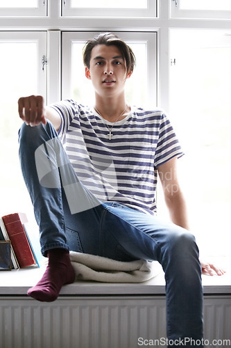 Image of Portrait, window and an asian man in the bedroom of his home to relax in the morning of a weekend in summer. Fashion, style and a confident young model chilling in his apartment for time off