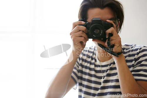 Image of Man, camera and photographer with vision, creative and art in apartment, pictures and inspiration. Male person, confident and photography or lens, vintage technology and retro equipment or gadget