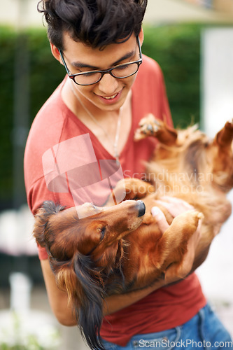 Image of Man, dog or playing in garden of home for bonding, love and relationship for happiness or joy. Person, pet or holding animal in backyard, outdoor or nature for care, friendship or companion and smile