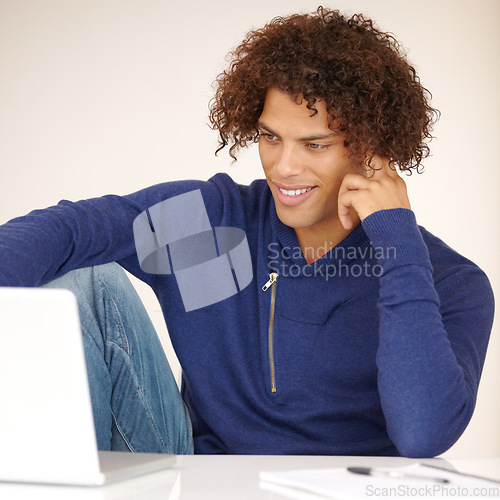 Image of Laptop, student and man online in studio for research, internet and reading news on website. Happy, university and person on computer for connection, elearning and education on white background