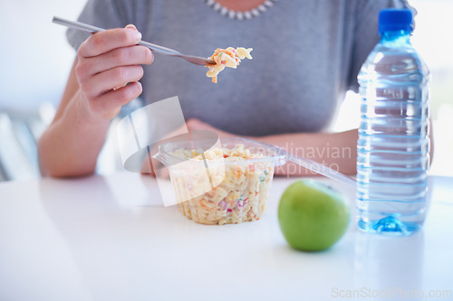 Image of Hand, fork and employee eating food in the cafeteria on a lunch break for health, diet or nutrition closeup. Water, apple and noodle salad with a business person in the office for a meal or snack