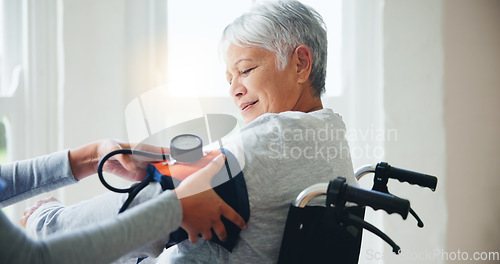 Image of Woman, doctor and senior in wheelchair for blood pressure, monitoring or elderly care at old age home. Nurse or medical caregiver checking BPM of mature patient or person with a disability at house