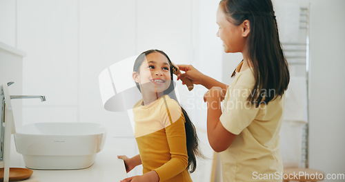 Image of Family, bathroom and a girl brushing the hair of her sibling in their home for morning routine or care. Kids, smile or haircare with a happy young child and sister in their apartment for hygiene