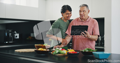 Image of Senior couple, tablet and recipe for meal, kitchen and cooking together for bonding, smile and support. Happy elderly people, healthy food and diet in retirement, fun and app for meal prep or web