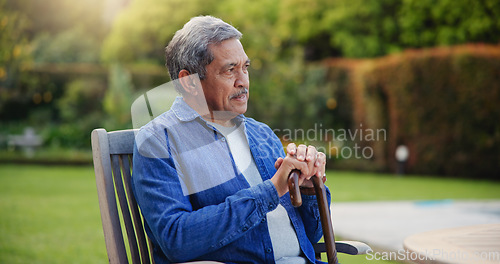 Image of Elderly, man or thinking with cane for retirement, alzheimer and memory outdoor on bench and lonely. Senior, person or walking stick with nostalgia, thoughtful and peace in nature or park with wonder