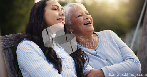 Image of Happy, senior and mother with woman on bench, nature and bonding hug for laugh on retirement. Mature person, parent and older daughter for together in park, care and love with funny joke in garden