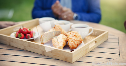 Image of Nutrition, breakfast and tray for morning, tea and fruit for diet, pastry and crossiants with strawberry, food or cup. Healthy living, fiber and beverage for thirst, coffee and fresh meal in backyard