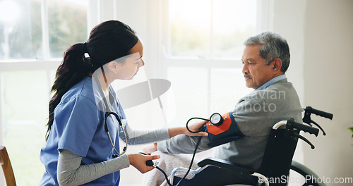 Image of Man, caregiver and senior in wheelchair for blood pressure, monitoring or elderly care at old age home. doctor or medical nurse checking BPM of mature patient or person with a disability at house