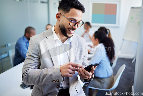 Image of Business man, phone and texting in meeting room, happy or email notification for deal, networking and company. Accountant, smartphone and smile in boardroom with typing, fintech or thinking at office
