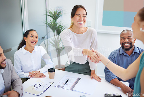 Image of Business people, handshake and finance meeting in team for promotion, onboarding or welcome to company. Asian woman, shaking hands or happy for congratulations, hiring or thank you with deal in group