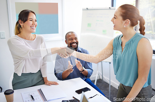 Image of Business women, shaking hands and finance team in meeting for promotion, onboarding or welcome to company. Accountant, handshake or happy for congratulations, hiring or thank you with deal in group