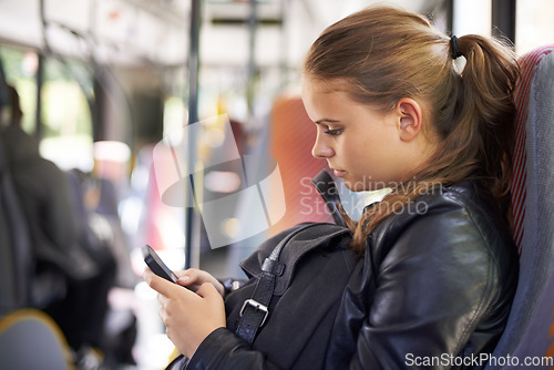 Image of Student, phone and transport to school on bus with a backpack and typing on social media. Teenager, girl and journey on public transportation or travel to college, campus or university with cellphone