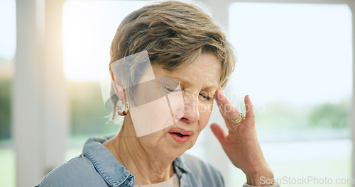 Image of Frustrated senior woman, headache and stress in burnout, anxiety or depression at home. Closeup of mature female person with migraine, pain or sore head in mental health, mistake or fail at house