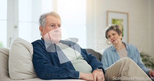 Image of Senior, couple or stress with conflict and fight on sofa in living room of home with anger and silence. Elderly, man or woman with argument, upset and frustrated on couch in lounge of house or ignore