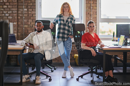 Image of A diverse group of young business individuals congregates in a modern startup coworking center, embodying collaborative innovation and a dynamic atmosphere.