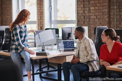 Image of A diverse group of young business individuals congregates in a modern startup coworking center, embodying collaborative innovation and a dynamic atmosphere.