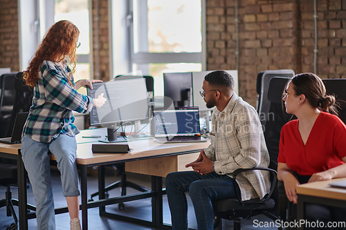 Image of A diverse group of young business individuals congregates in a modern startup coworking center, embodying collaborative innovation and a dynamic atmosphere.