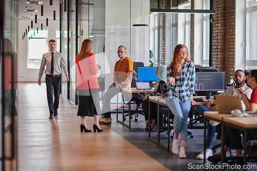 Image of A diverse group of young business individuals congregates in a modern startup coworking center, embodying collaborative innovation and a dynamic atmosphere.