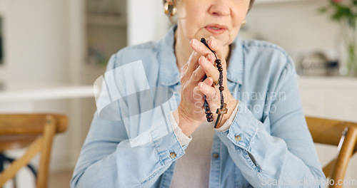 Image of Closeup, old woman or rosary for prayer, faith or religion with guidance, spiritual or peace in a lounge. Apartment, pensioner or elderly person with beads, Christian or worship with Catholic or home