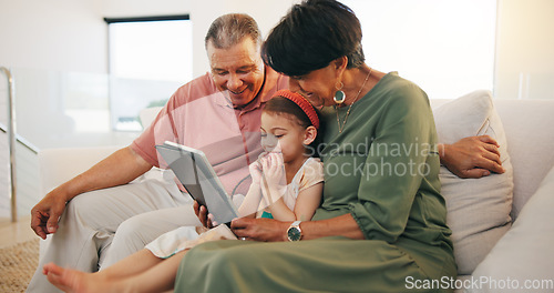 Image of Tablet, elearning and child with grandparents on sofa in the living room of modern family house. Happy, online school and girl on digital technology relaxing with senior people in retirement at home.