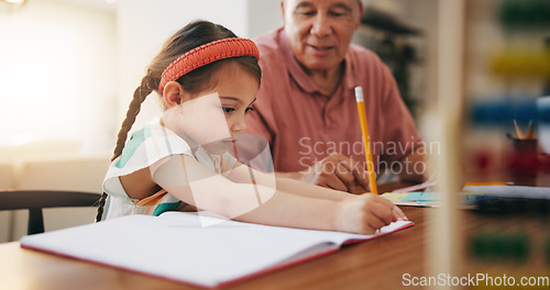 Image of Grandfather, little girl and writing in book for learning, literature or education together on desk at home. Grandpa, child or kid taking notes in homeschool to read and write on table at house