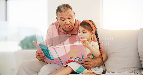 Image of Grandpa, child and reading book on sofa for literature, education or bonding together at home. Grandparent with little girl or kid smile for story, learning or relax on living room couch at house