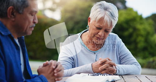 Image of Old couple and pray at bible for religion faith or god hope or holy spirit praise, study for worship. Senior, people and hands for support reading or help research for belief, christian or education