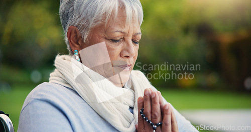 Image of Senior woman, praying hands or rosary in wheelchair in nature, faith or hope in retirement. Mature person, catholic or meditation or praise to god, garden or petition as intercessor for jesus christ