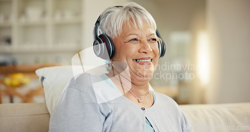 Image of Senior woman, home and headphones for music, listening to audio and radio podcast on sofa. Happy elderly lady, relax and thinking of peace, streaming sound and multimedia subscription in living room