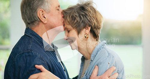 Image of Senior couple, forehead or kiss of love in support, loyalty or commitment in retirement in family home. Mature man, woman or marriage in gratitude for together in trust, security or care in apartment