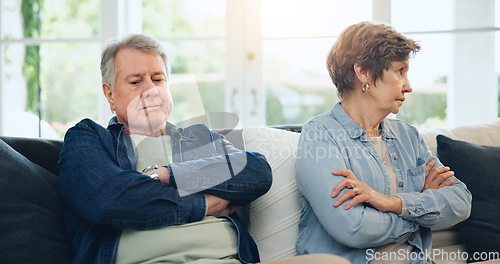 Image of Senior, couple and stress with divorce and fight on sofa in living room of home with anger and silence. Elderly, man or woman with argument, upset and frustrated on couch in lounge of house or ignore