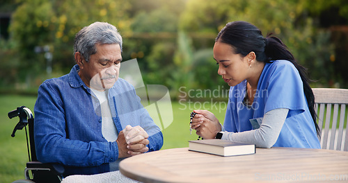 Image of Wheelchair, praying or nurse with senior man for care, support or trust in retirement or nature. Caregiver, help and person or elderly patient with a disability or medical professional for worship