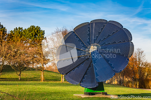 Image of Rotating solar panel in flower shape in a city park. Photovoltaic, alternative electricity source