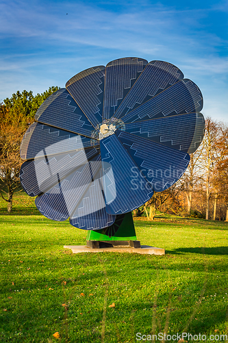 Image of Rotating solar panel in flower shape in a city park. Photovoltaic, alternative electricity source