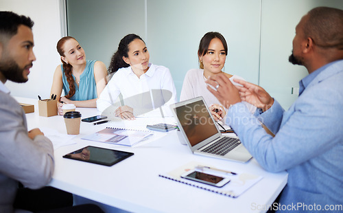 Image of Businessman, team and discussion with laptop in boardroom for collaboration, leadership or advice. Diversity, mentor and talking for guidance, training or strategy for online, report and document