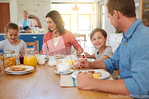 Image of Food, breakfast and love with a family in the dining room of their home together for nutrition. Portrait of a boy with his parents and sister eating at a table in an apartment for morning bonding