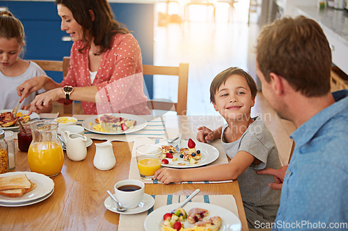 Image of Food, breakfast and a playful family in the dining room of their home together for health or nutrition. Mother, father and cute sibling kids eating at a table in their apartment for love or bonding