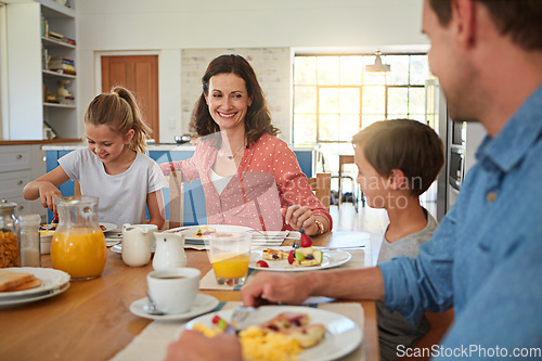 Image of Smile, food and morning with a family in the dining room of their home together for health or nutrition. Mother, father and happy sibling kids eating breakfast at a table in an apartment for bonding